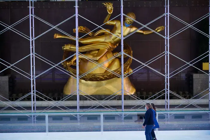People wearing face masks enjoy skating on the first day of opening of Ice Rink at Rockefeller Center.